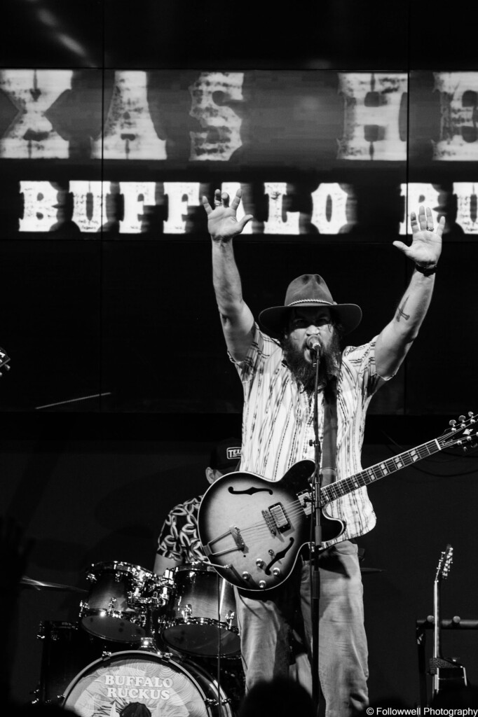 Arms raised on stage with The Buffalo Ruckus