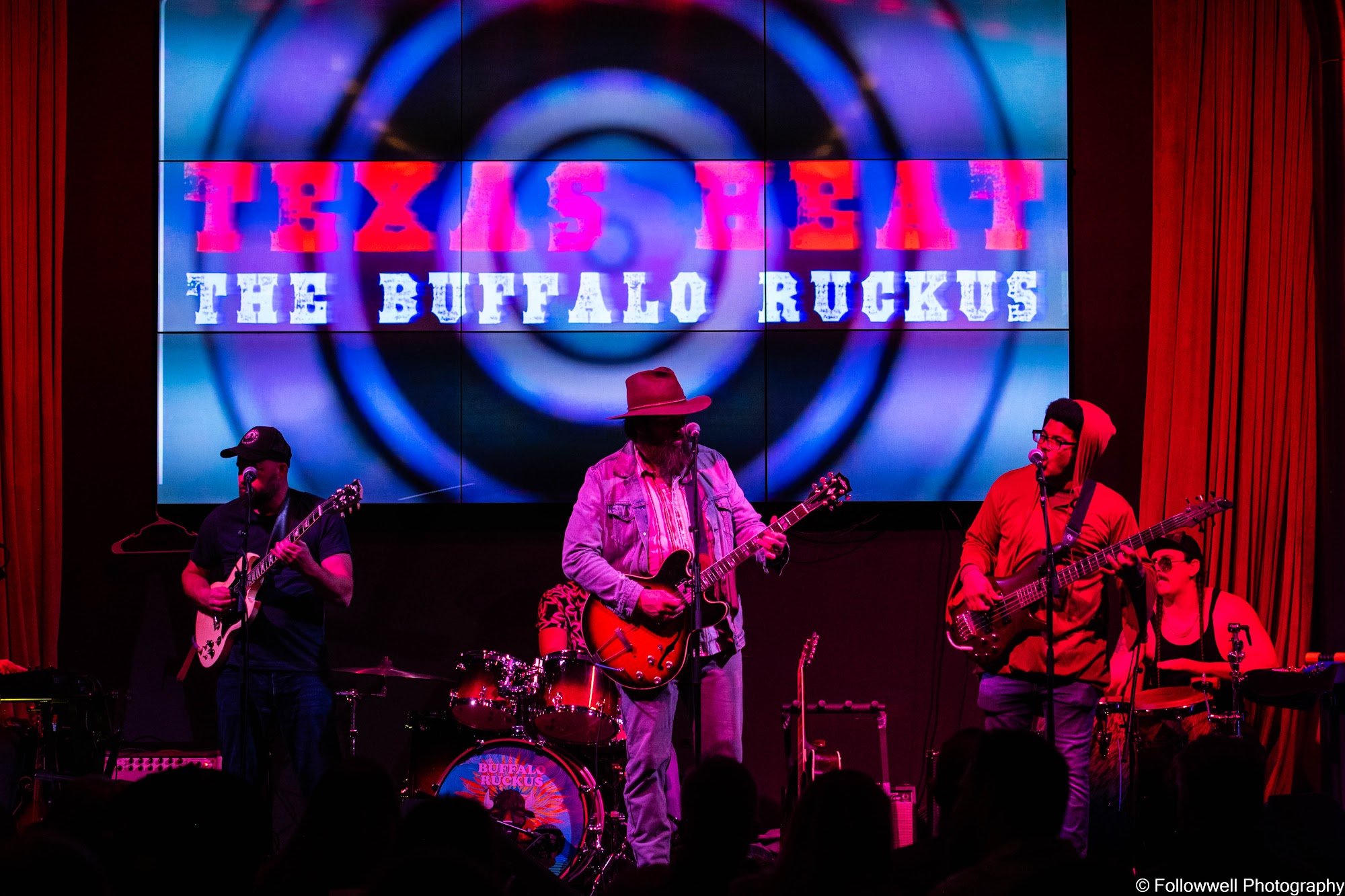 The Buffalo Ruckus on stage under the Texas Heat screen